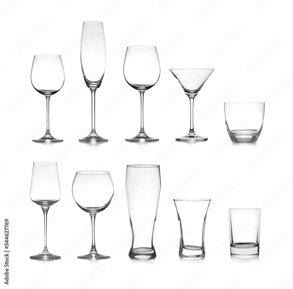 Set of different empty glasses on white background