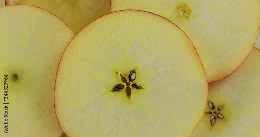 Fresh apple slices. The apple sliced ​​into pieces is rotated for 4 shots. Organic, red, sliced, vegetarian.