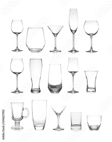 Set of different empty glasses on white background