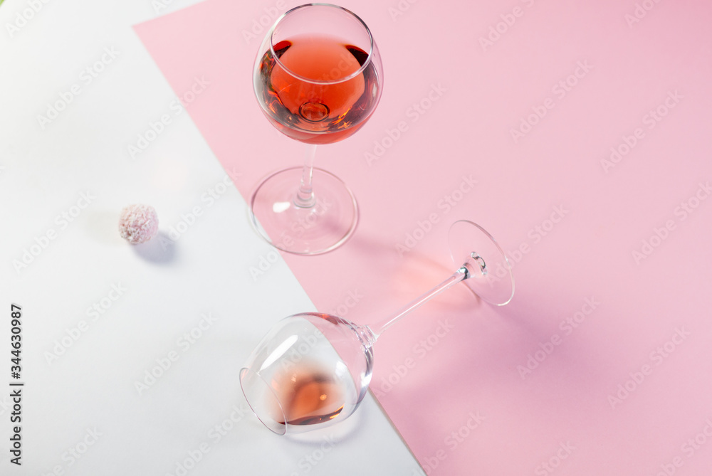 Rose wine glasses and sweet balls on white and pink background Rose wine glasses and sweet balls on white and pink background