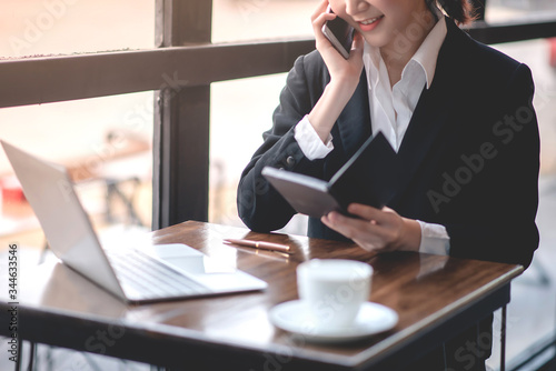 Businessmen are discussing business via phones and laptops. © Daenin