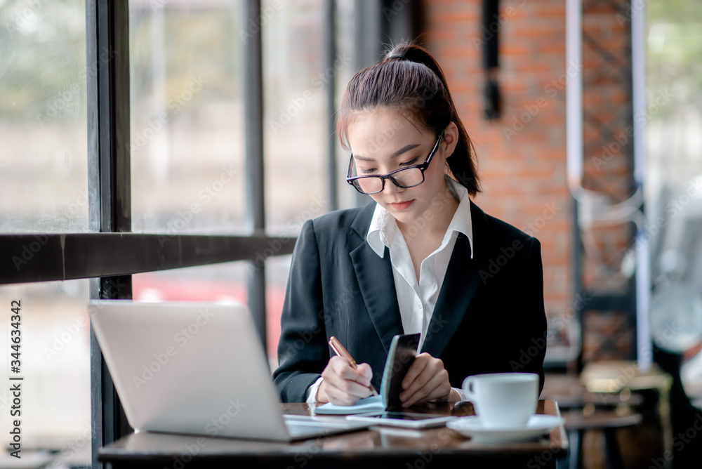 Businessman analyzing and recording information about financial business Businessman analyzing and recording information about financial business