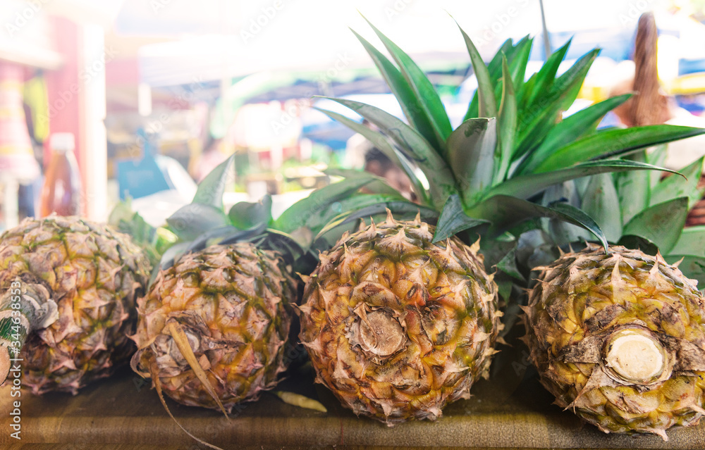 Close up of pineapples for sale at the street market.