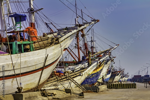 Fishing boats lined up in the harbor at Sunda Kelapa Port. Jakarta city, Java Island, Indonesia 