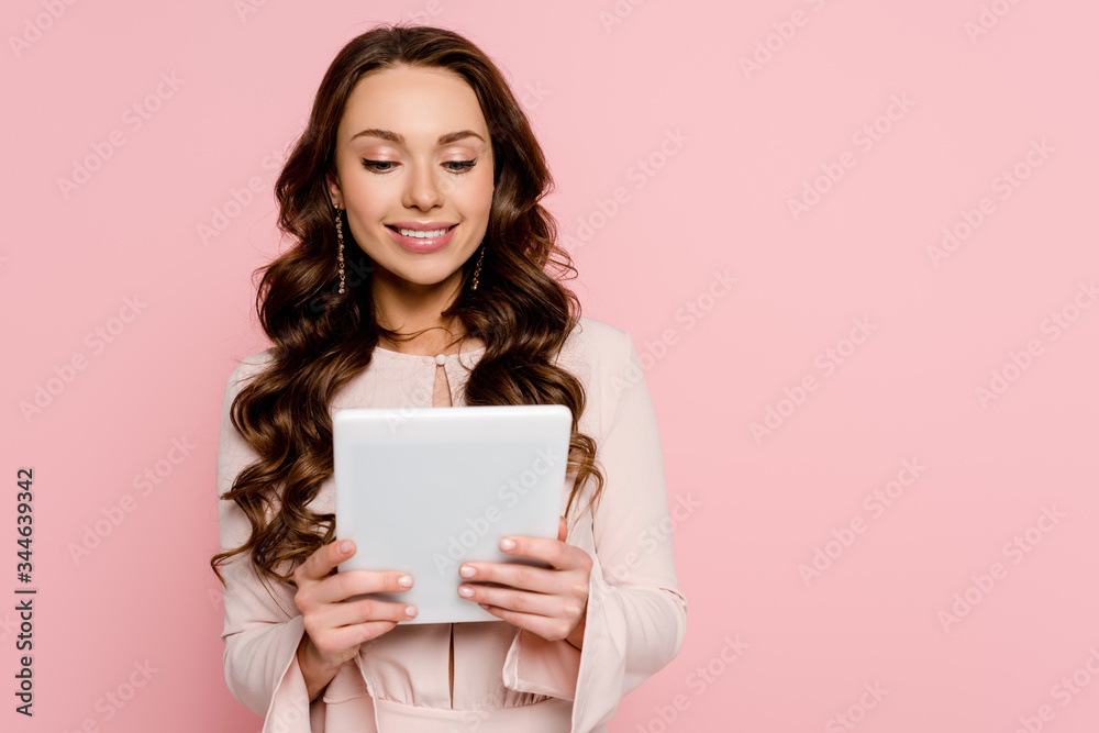 happy young woman using digital tablet isolated on pink happy young woman using digital tablet isolated on pink