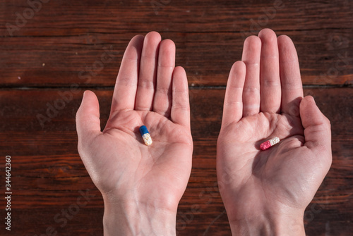 blue and red pill in the palm of your hand, pills in your hands