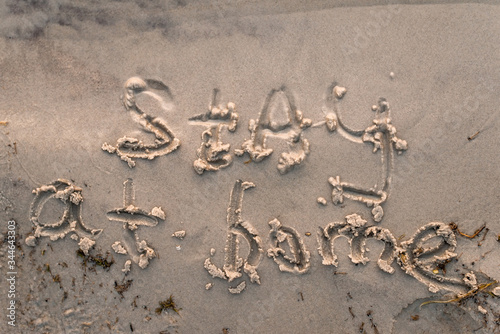 message stay home on the beach in the sand