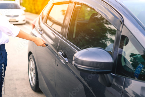 A focus image of a businesswoman s hand pressing a close-up car key in the evening after work