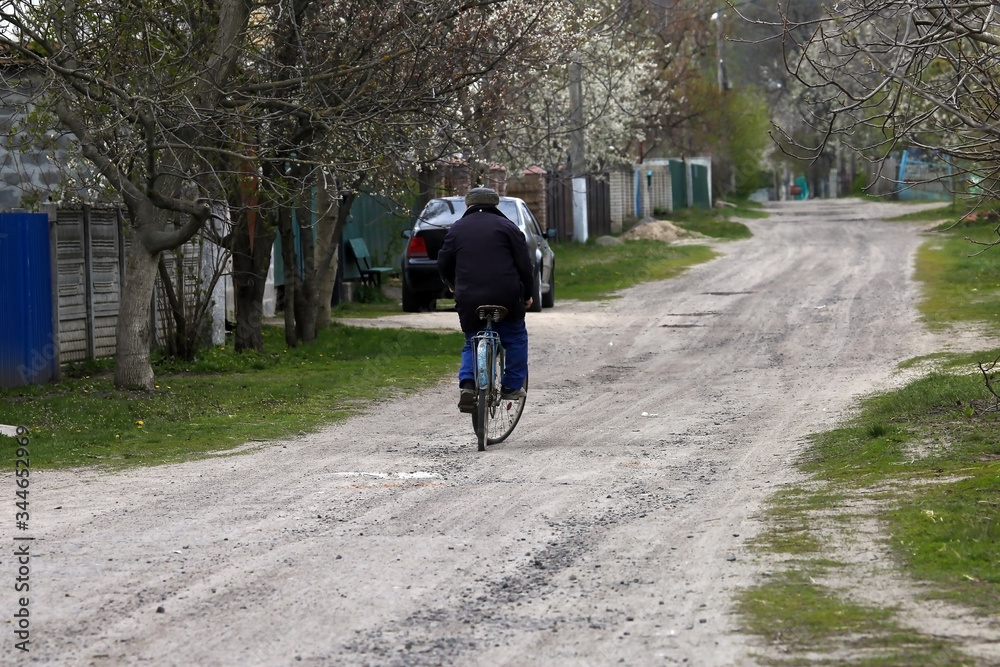 Fototapeta premium cyclist rides on a rural road