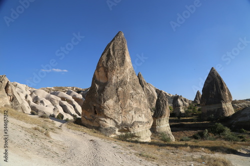 View of valley and rock formations in Cappadocia Turkey. Tuff volcanic cliffs and sandstone hills landscape.