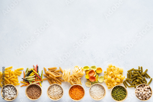Italian Macaroni Pasta raw food background, texture close up. The concept of Italian cuisine, cooking with love.