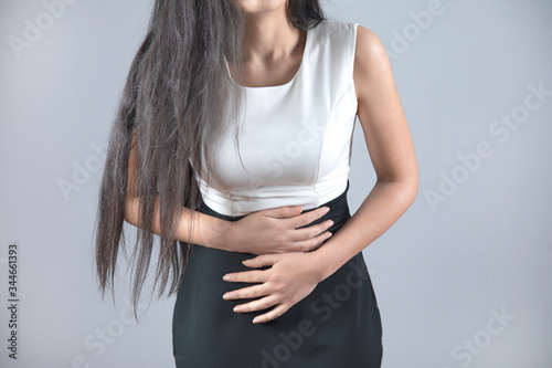 woman hand in ache belly