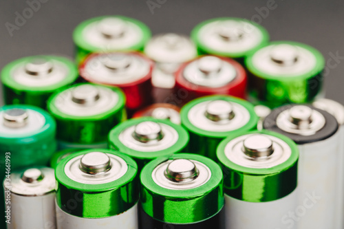 Closeup of group of used disposable  batteries of various color.
