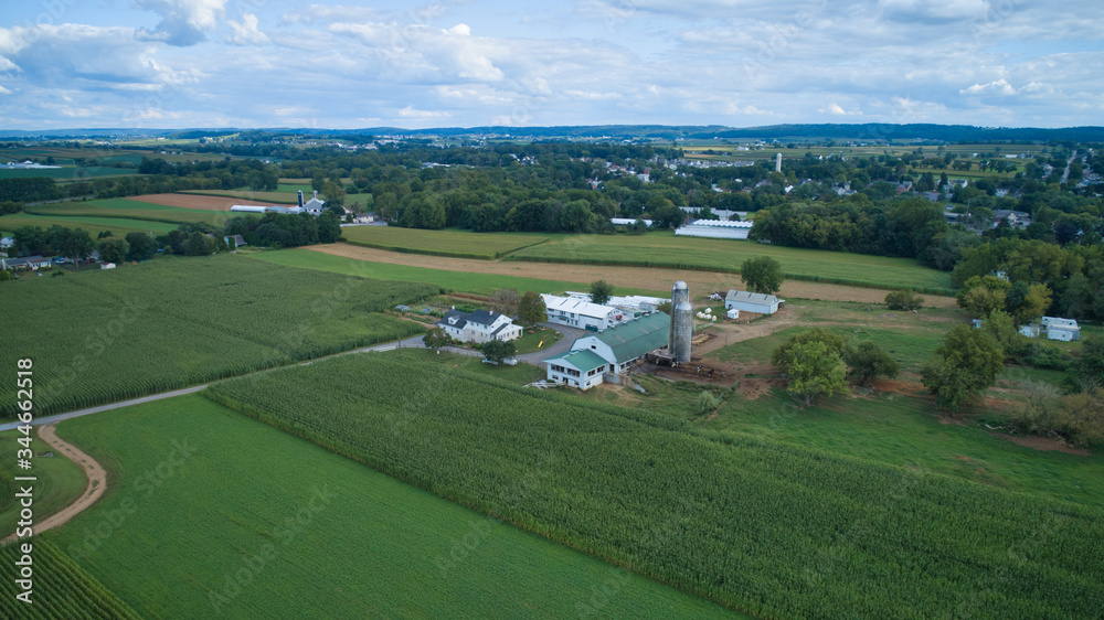 Aerial view of Amish countryside with barns and silos on a sunny summer day