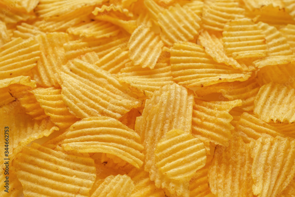 Golden potato chips background. Selective focus, copy space for text Golden potato chips background. Selective focus, copy space for text