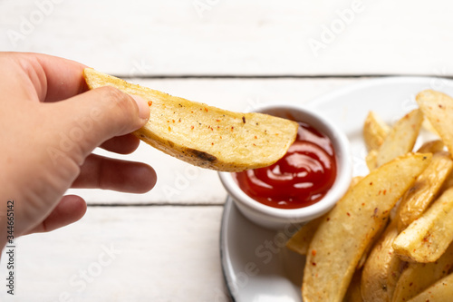 French fries with ketchup sauce on white background
