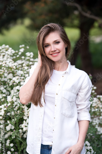 Woman smiling with perfect smile and white teeth in a park