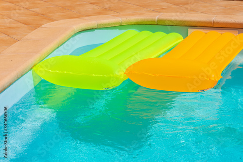 red inflatable mattress in pool