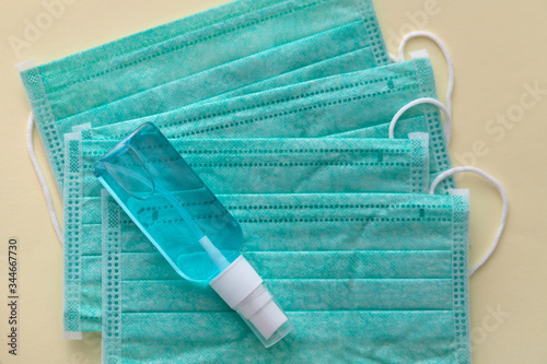 Medical masks and hand sanitizer blue bottle, anti-infective hygienic and health protection concept, Coronavirus Covid-19 photo