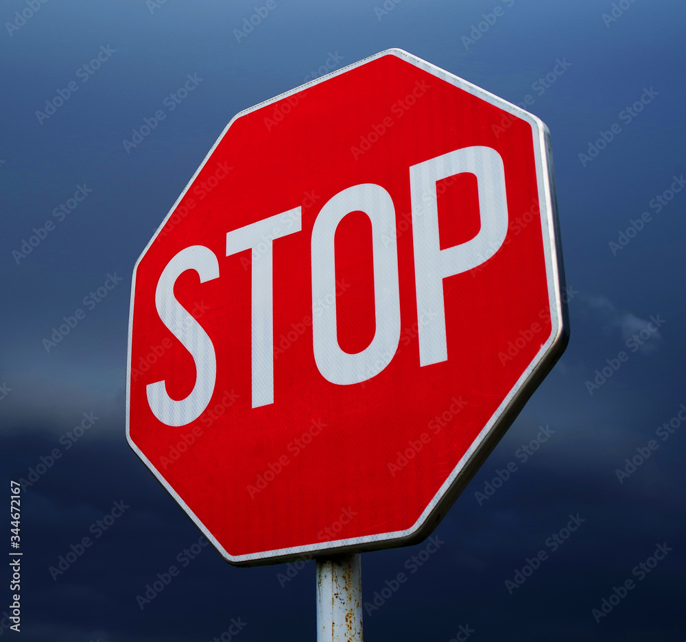 Conceptual stop sign with stormy background. Warning, caution and danger sign