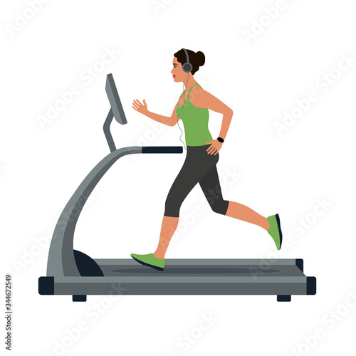 woman in sportswear running on treadmill in headphones