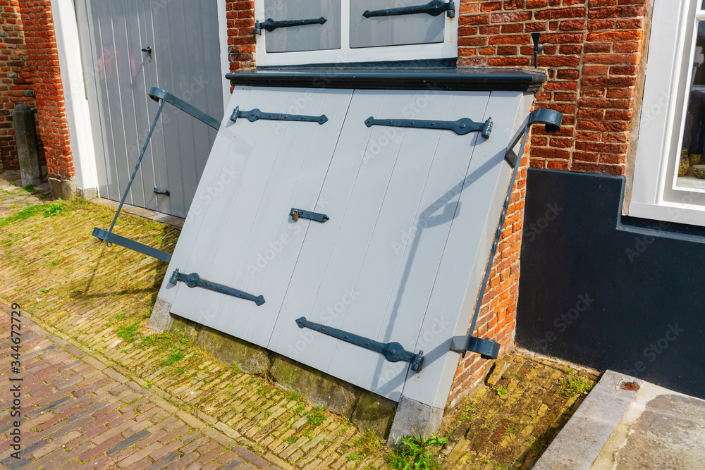 antique coal cellar door in Veere, Netherlands antique coal cellar door in Veere, Netherlands