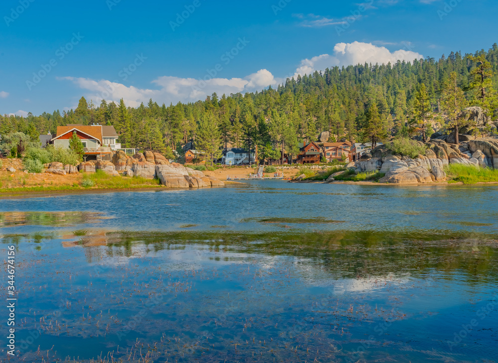 Fototapeta premium Cabins reflect into the Back bay of Boulder Bay, Big Bear Lake, California