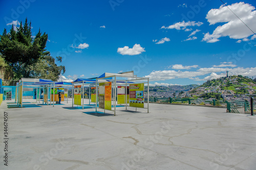 QUITO, ECUADOR, FEBRUARY 02, 2018: Outdoor view of informative adversisements in plastic structures of Yaku museum of water located in the city of Quito, with the city buildings in the horizont photo