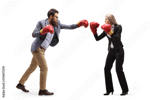Man and woman in formal clothes fighting with boxing gloves
