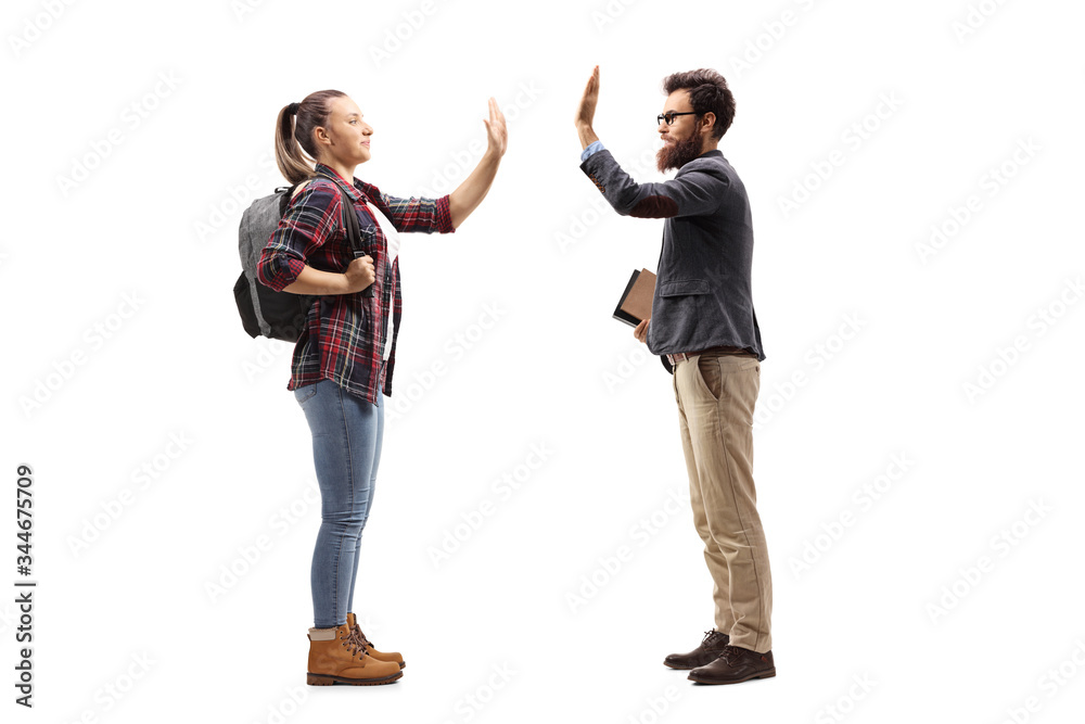 Female student gesturing high-five with a male teacher