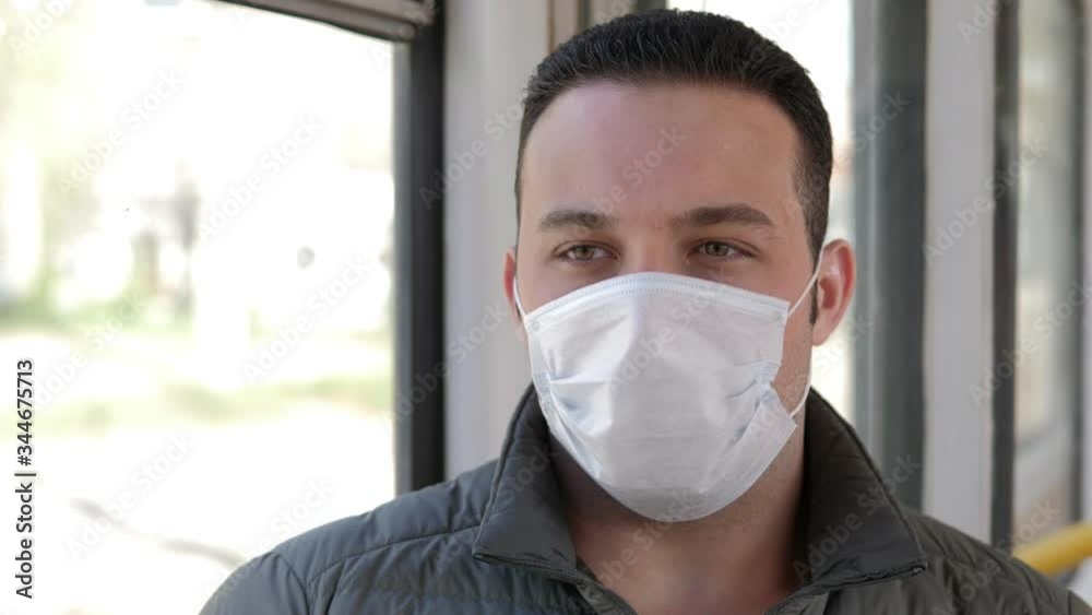 Man with disposable mask on bus. Virus protection Man with disposable mask on bus. Virus protection