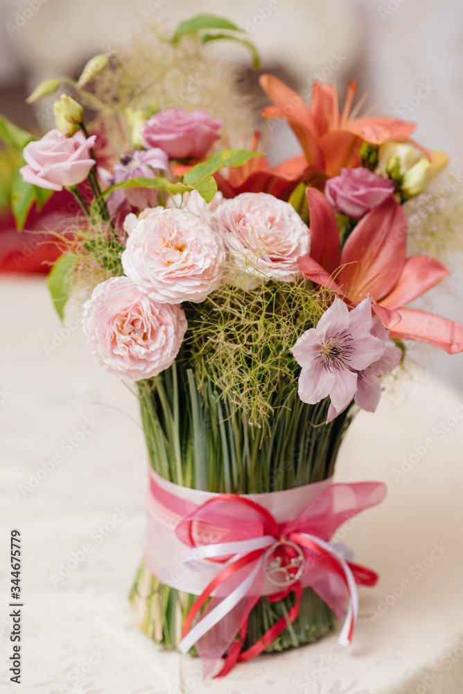 A beautiful stylish bouquet stands on the table close-up A beautiful stylish bouquet stands on the table close-up
