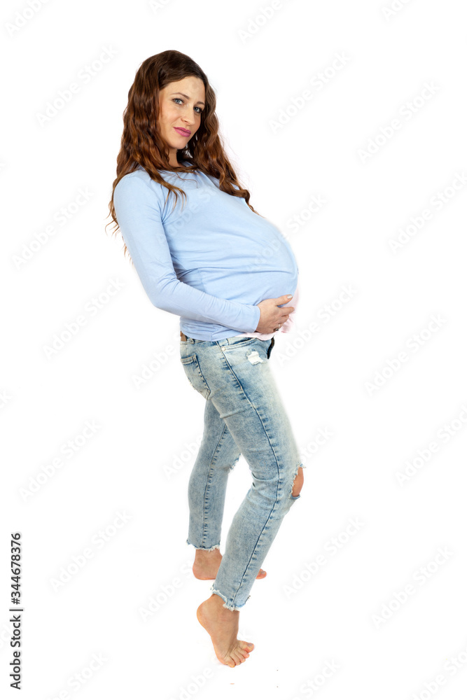 Adorable barefoot pregnant woman isolated on white Adorable barefoot pregnant woman isolated on white