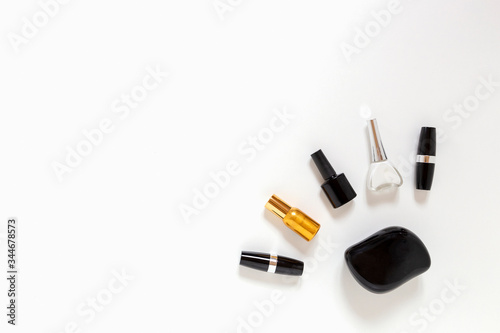 Golden perfume, white and black nail polish , comb, black lipsticks flat lay with copy space