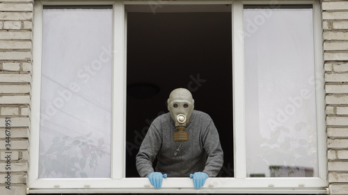 Wallpaper Mural Old man in gas mask stay at window isolated at home on quarantine. Coronavirus Torontodigital.ca