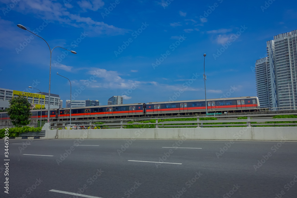 SINGAPORE, SINGAPORE - FEBRUARY 01, 2018: Outdoor view of Singapore mass rapid train MRT travels on the track. The MRT has 106 stations and is the second-oldest metro system in Southeast Asia