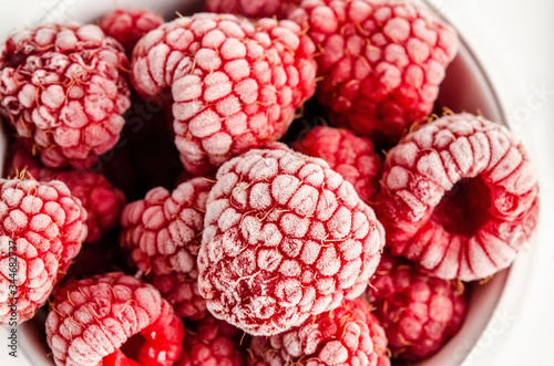 Frozen berries and raspberries on a white background. Top view  season concept  season.