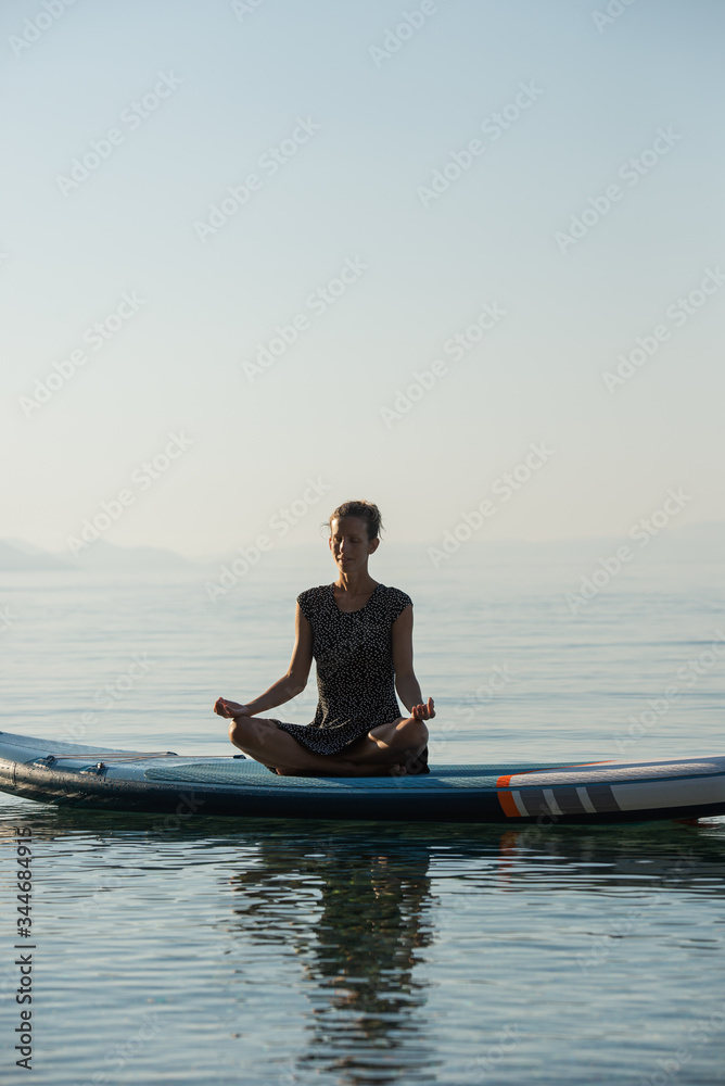 Young woman meditating in lotus position