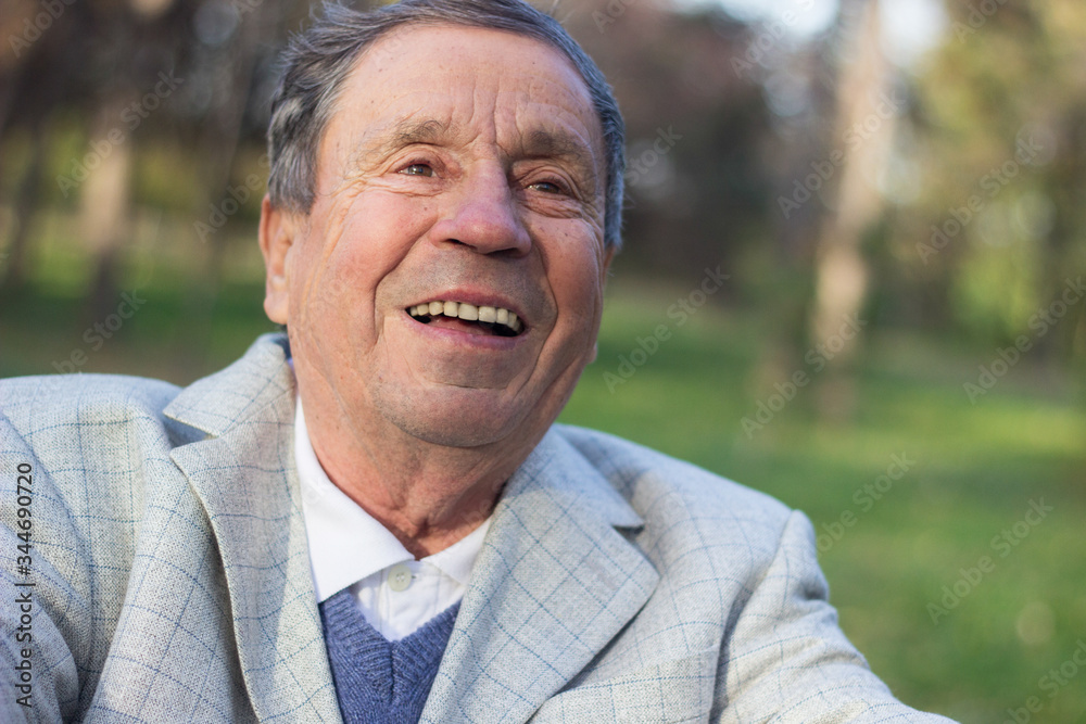 Portrait of a smiling senior man in Nature, looking away Portrait of a smiling senior man in Nature, looking away