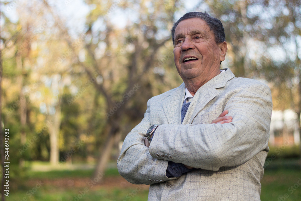 Portrait of a smiling senior man in Nature, looking away Portrait of a smiling senior man in Nature, looking away