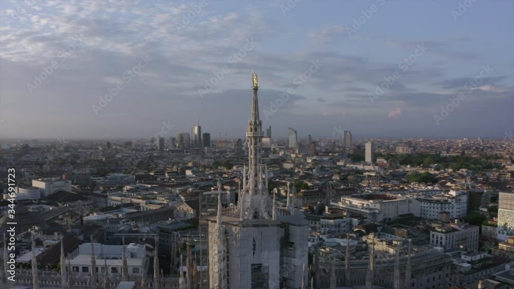 Aerial view of Duomo cathedral in Milan, Italy and Porta Nuova skyscrapers in background seen from drone flying in the sky. Milano, Italian city and city landscape at sunset Aerial view of Duomo cathedral in Milan, Italy and Porta Nuova skyscrapers in background seen from drone flying in the sky. Milano, Italian city and city landscape at sunset