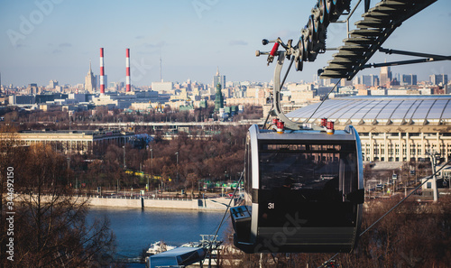Sunny super-wide angle view from Sparrow Hills (Vorobyovy Gory), Moscow, Russia, with Luzhniki Stadium, Moscow cable car ropeway gondola, and scenery panorama beyond the city