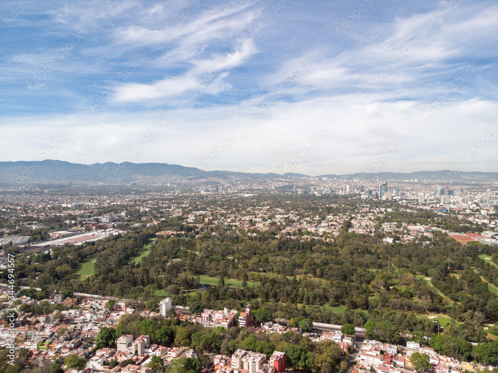 Aerial panoramic view of a Golf Course in Mexico City with a blue sky as background