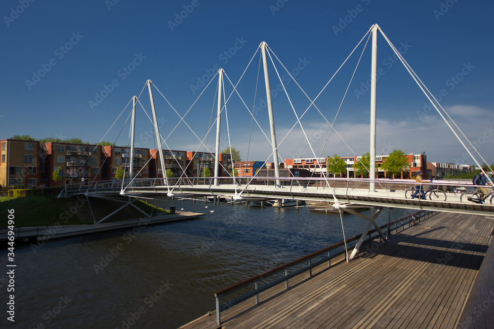 Almere, Netherlands - April 22 2019: Pedestrian bridge over a canal