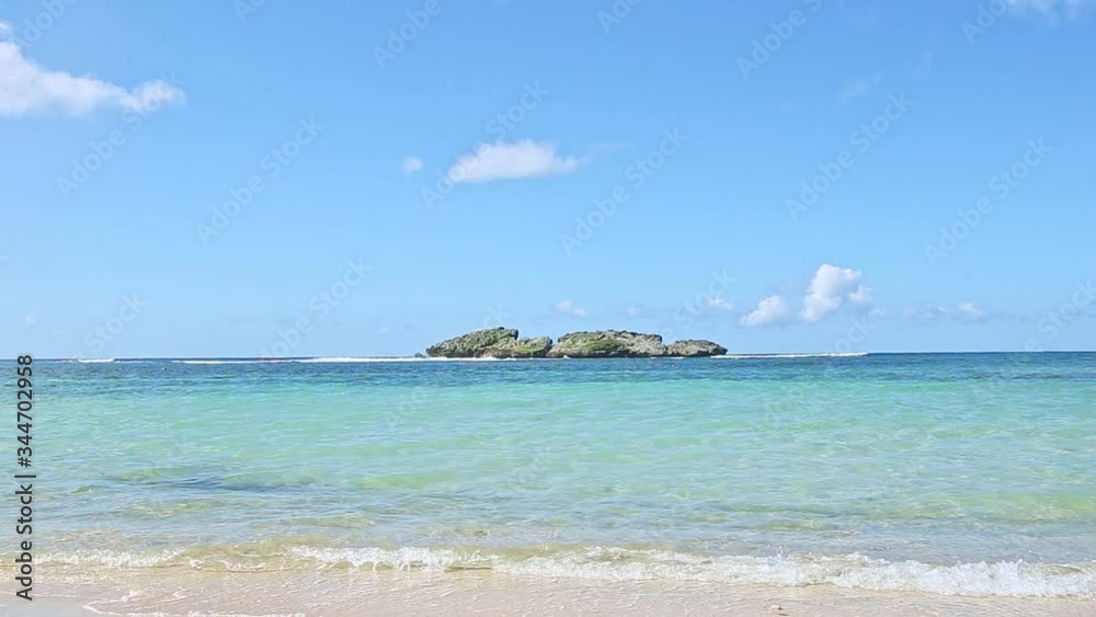 panorama at small white waves ran from blue ocean to golden sandy beach panorama at small white waves ran from blue ocean to golden sandy beach