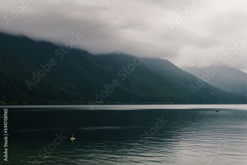 Beautiful Chilliwack lake green forest and cloudy sky british columbia canada. © olegmayorov