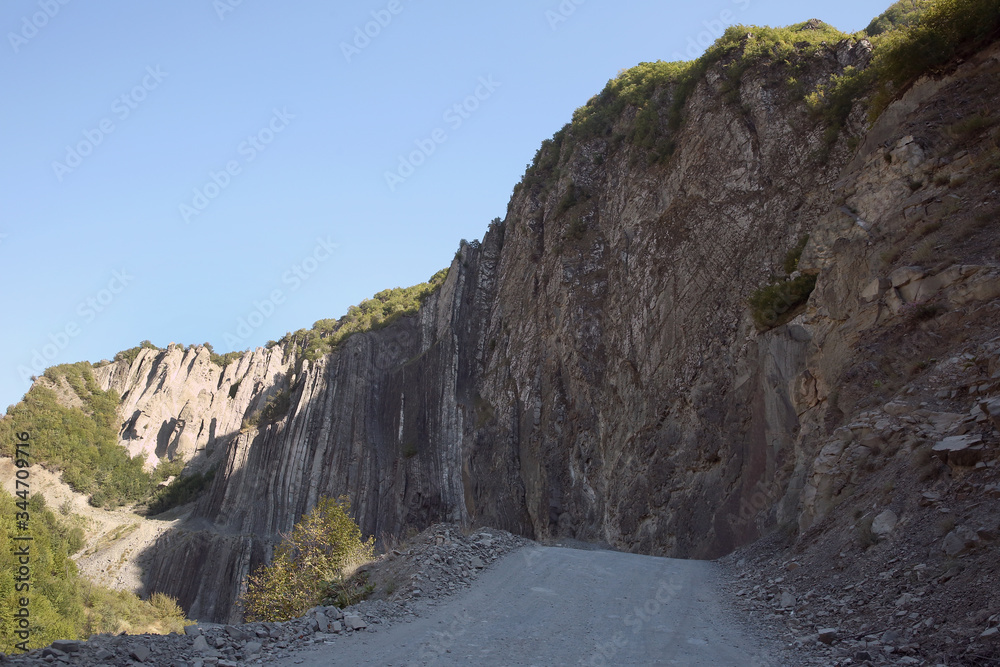 Mountainous road leading to Lahic village in Ismayilli region of Azerbaijan, with car.