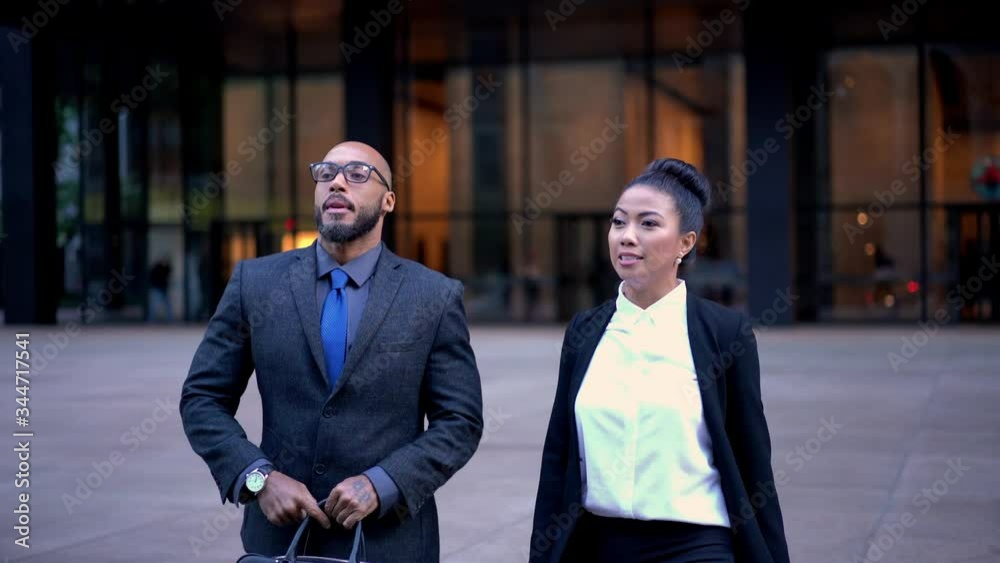 Confident male and female colleagues sit down in car vehicle for getting to destination in financial district of Manhattan, businessman dressed in luxury suit opening door of company auto
