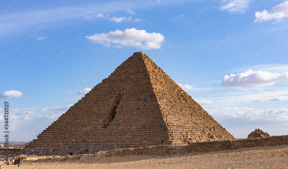 Cairo, Giza, Pyramid of Menkaure (Mykerinos, Menkheres), Egypt. Pyramid on the background of the evening cloudy sky.