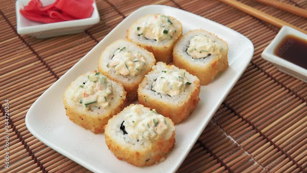 tempura Maki sushi rolls with cream cheese, on a white plate close-up.